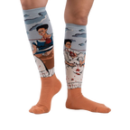 Lifestyle shot of The Two Fridas socks on a person's legs, showcasing the fit and design against a white background.