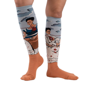 Lifestyle shot of The Two Fridas socks on a person's legs, showcasing the fit and design against a white background.