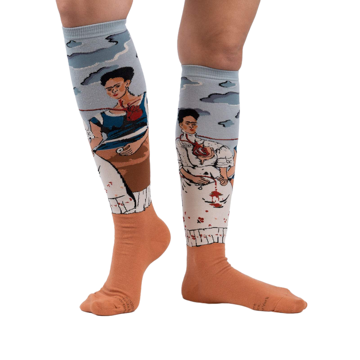 Lifestyle shot of The Two Fridas socks on a person's legs, showcasing the fit and design against a white background.