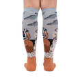 Back view of The Two Fridas socks on a person's legs, highlighting the sock's full design and detailing.