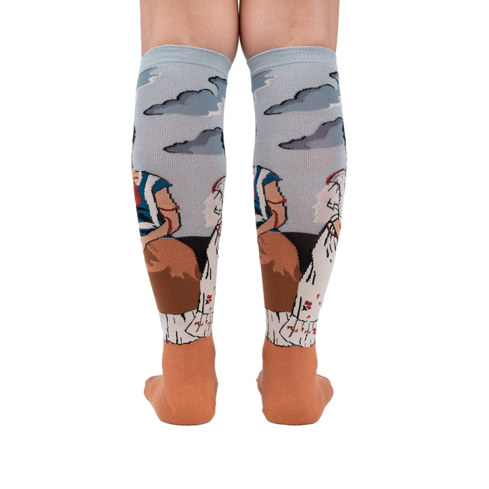 Back view of The Two Fridas socks on a person's legs, highlighting the sock's full design and detailing.