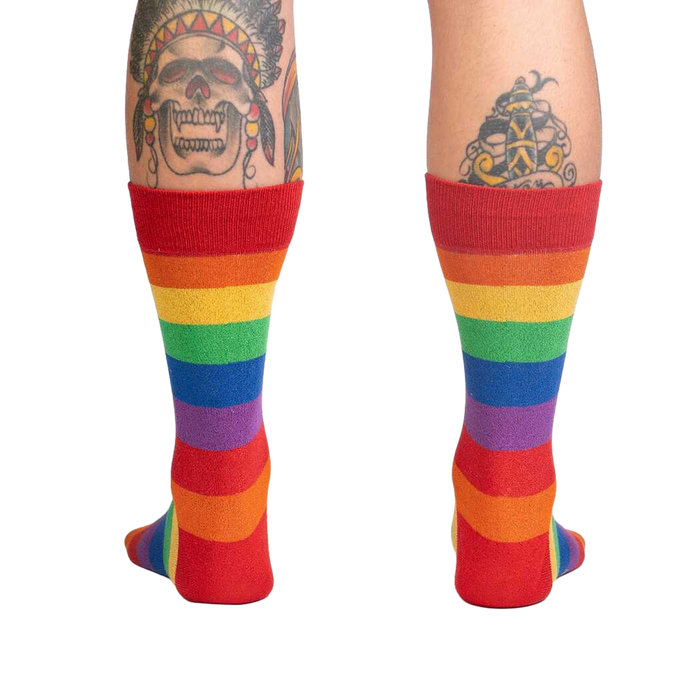 Rear view of the rainbow shimmer socks on a person's legs.