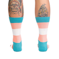 Back view of the Trans Pride socks on a person's legs.