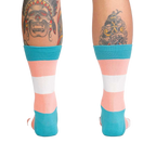 Back view of the Trans Pride socks on a person's legs.