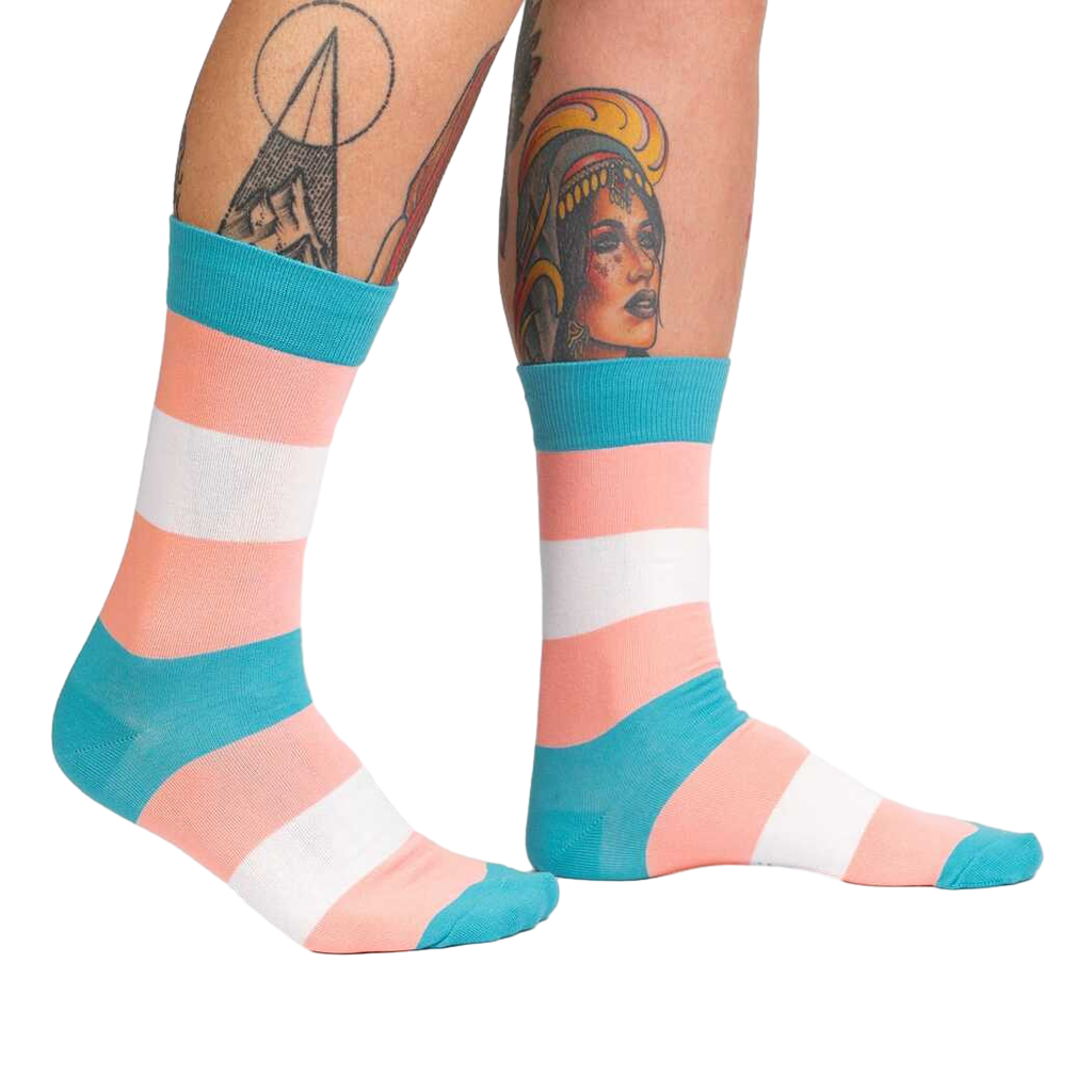 Lifestyle shot of Trans Pride socks on another person's legs, showing the socks from a different angle.