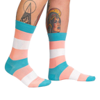 Lifestyle shot of Trans Pride socks on another person's legs, showing the socks from a different angle.
