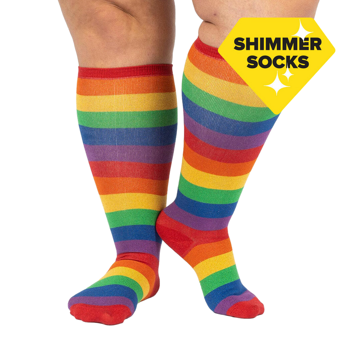Lifestyle shot: A person's legs wearing the rainbow knee-high socks. The socks are the focus; the background is plain white.