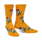 A pair of mustard-yellow crew socks featuring colorful gnomes skateboarding and carrying boomboxes. 