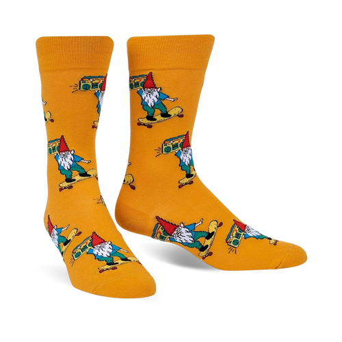 A pair of mustard-yellow crew socks featuring colorful gnomes skateboarding and carrying boomboxes. 