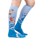 Lifestyle shot of a person wearing the 'Beauty in Water' knee-high socks, showcasing the design and fit.
