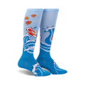Pair of blue knee-high socks with a design of koi fish swimming in stylized waves and autumn leaves. 