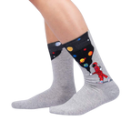Lifestyle shot showing the 'Moon Walk in the Morning' socks on a person's legs against a black background.
