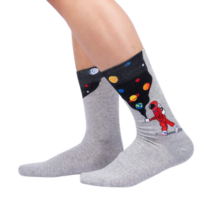 A pair of gray socks with an image of a golfer on each sock. The golfer is wearing a red shirt and white pants.