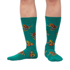 Lifestyle shot showing the Poison Dart Frog socks on a person's legs, showcasing the fit and pattern.