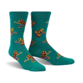 Pair of teal crew socks with a pattern of colorful poison dart frogs.  Orange, yellow, and black frogs on a teal background.
