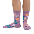 Lifestyle shot showing the pufferfish socks on a person's feet. The socks are crew length and feature a fun design.
