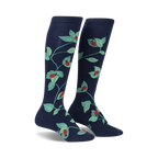 Pair of navy blue knee-high socks with a repeating pattern of ladybugs and green leaves.