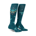 Pair of teal knee-high socks featuring a repeating pattern of mystical moths, celestial moons, and stars. 