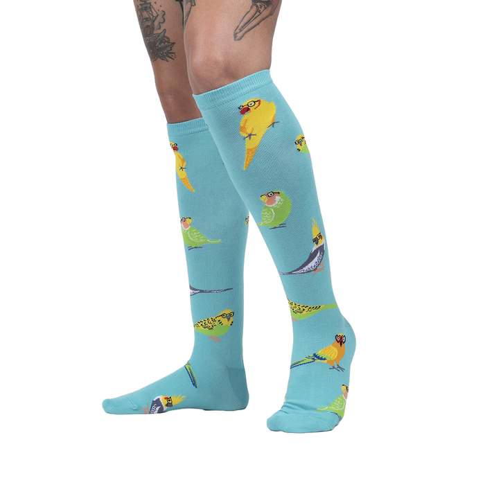 Lifestyle shot: Model wearing the Pretty Birds knee-high socks, showing off their fun style.