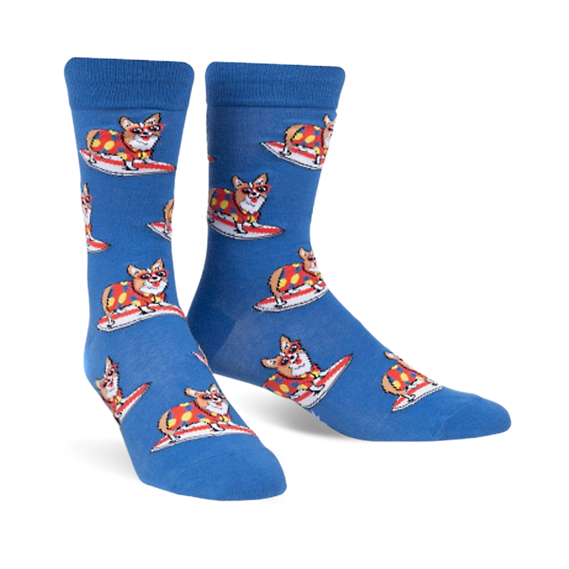 Pair of blue crew socks with repeating pattern of corgis wearing colorful shirts and surfing. 