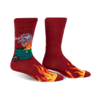 A pair of men's crew socks in red, featuring a burning dumpster graphic, flames along the bottom, and the text 'Greetings From'.