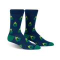 Pair of crew socks in navy blue with repeating lime green and darker green Christmas tree pattern. Green cuffs.