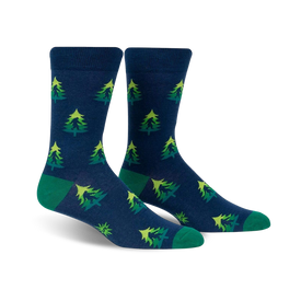 mens dark blue crew socks featuring forest green pine trees pattern with green toes and heels. perfect for casual wear.  