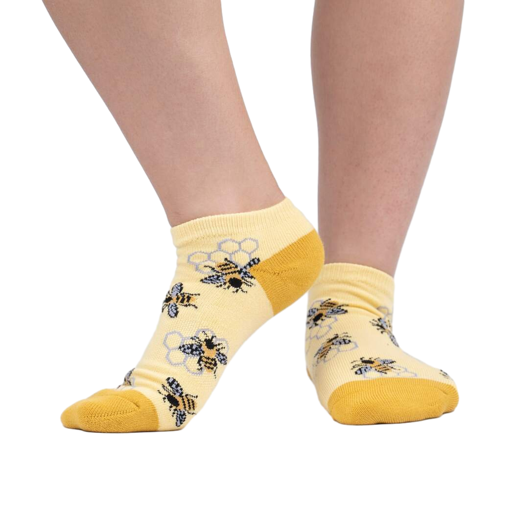 Lifestyle photo showing the socks on a person's feet against a white background.