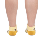 Rear view of a person wearing the bee socks against a white background.