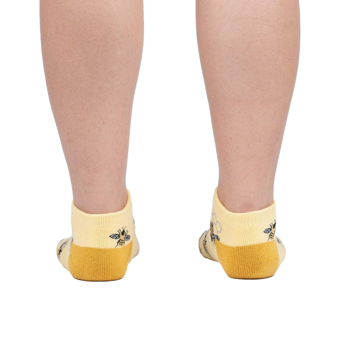 Rear view of a person wearing the bee socks against a white background.