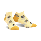 Pair of pastel yellow ankle socks with a pattern of bees and honeycombs.  The socks have a mustard yellow heel and toe.