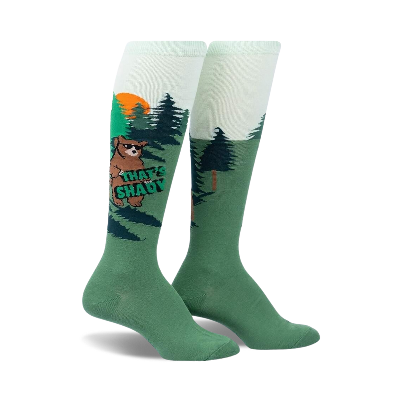 Knee-high socks in green and light green featuring a cartoon bear wearing sunglasses in a forest scene.  The words 'That's Shady' are on the sock.