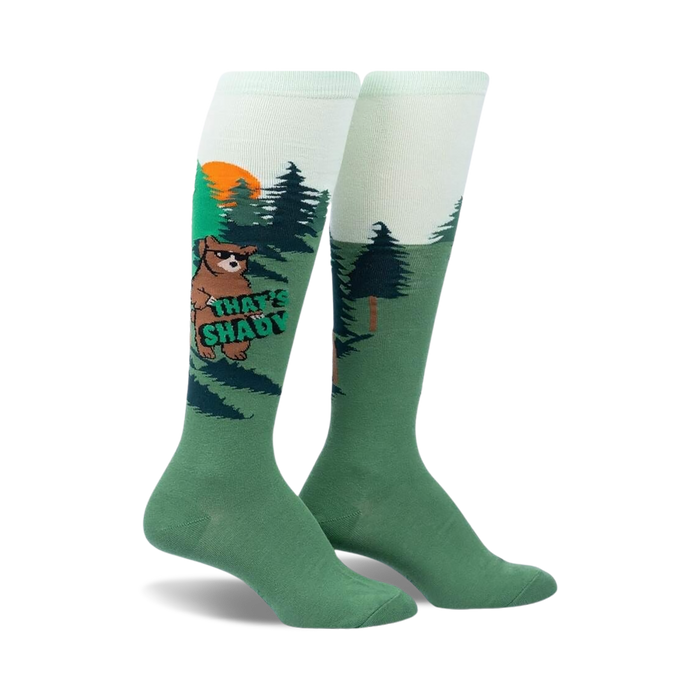   green knee-high socks with bears wearing sunglasses and holding signs that say 'that's shady' in front of a sunset and pine trees.    