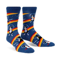 Crew socks in blue with a repeated pattern of Boston Terriers wearing astronaut helmets on a rainbow stripe in space. 