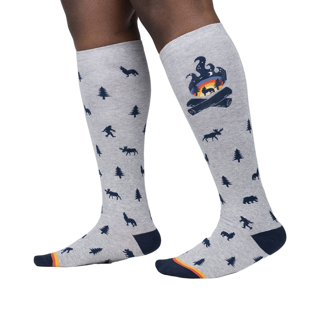Lifestyle shot of a person wearing the Magic Of The Forest knee-high socks, showcasing the design and fit.