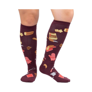 Lifestyle shot of 'Bake at 350' knee-high socks in burgundy on a person's legs against a white background.