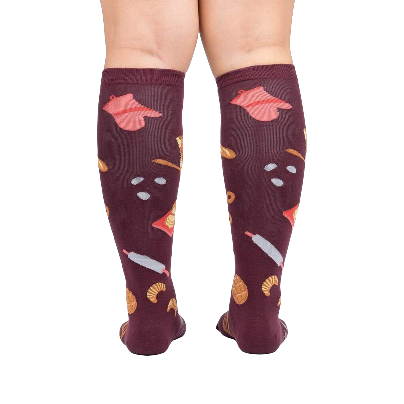 Back view of 'Bake at 350' burgundy knee-high socks on a person's legs against a white background.