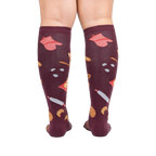 Back view of 'Bake at 350' burgundy knee-high socks on a person's legs against a white background.