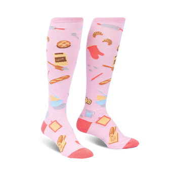 knee high pink women's socks with a pattern of baking items such as a rolling pin, whisk, oven mitt, bread, pie and flour.   