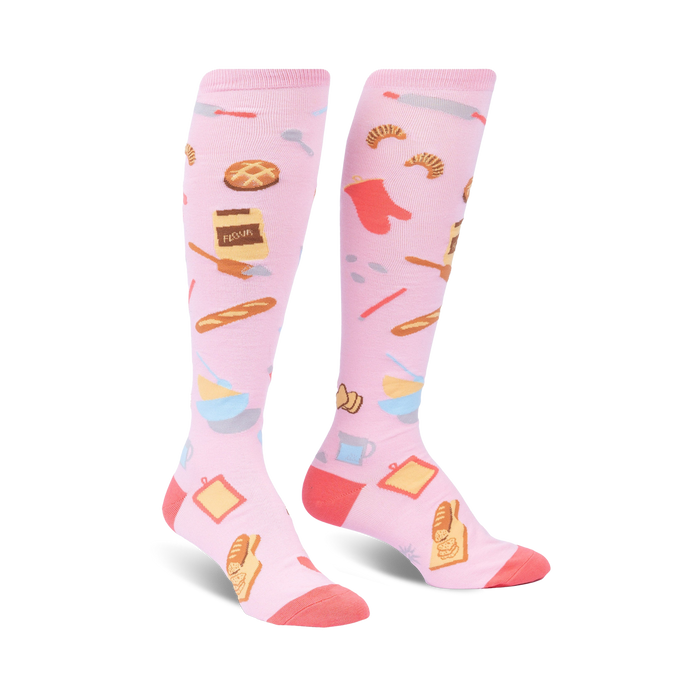 knee high pink women's socks with a pattern of baking items such as a rolling pin, whisk, oven mitt, bread, pie and flour.   