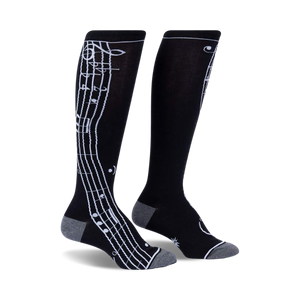 black knee-high socks decorated with a fun repeating pattern of musical notes in white, perfect for music-loving women.  