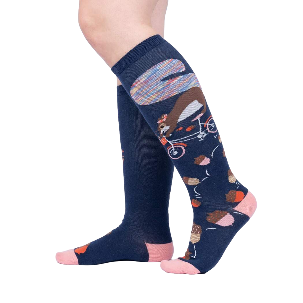 Lifestyle shot showing the 'Feeling Squirrelly' knee-high socks on a person's legs against a light gray background.