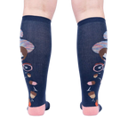 Rear view of the 'Feeling Squirrelly' knee-high socks on a person's legs, highlighting the full design on both socks.