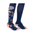 Pair of navy blue knee-high socks with a whimsical design: a squirrel riding a bicycle amidst acorns and a colorful background detail.