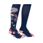 Pair of navy blue knee-high socks with a whimsical design: a squirrel riding a bicycle amidst acorns and a colorful background detail.