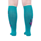 Rear view of teal knee-high socks, showcasing the full peacock design on the back of the socks.