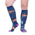Lifestyle shot: A person's legs wearing the Hmmmmmingbird knee-high socks, showcasing the design and fit.