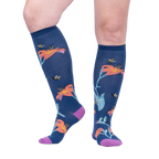 Lifestyle shot: A person's legs wearing the Hmmmmmingbird knee-high socks, showcasing the design and fit.