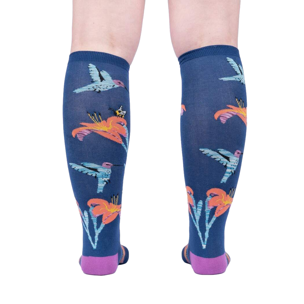 Back view of the Hmmmmmingbird socks on a person's legs.  Shows the full design repeat on the back of the socks.