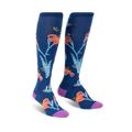 Pair of knee-high socks in navy blue.  Features a whimsical design of orange lilies, hummingbirds, and bees.